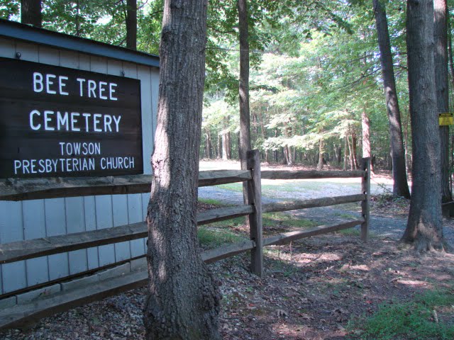 Bee Tree Cemetery Towson Presbyterian Church sign on shed behind thin wooden fence.